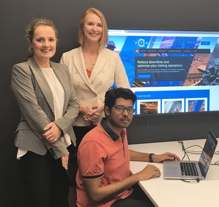 PETRA Data Science’s MD Penny Stewart (Left) with CEEC CEO Alison Keogh and Unearthed Brisbane winner and PETRA Data Science’s Arun Pillal (seated). (Photo courtesy PETRA Data Science).